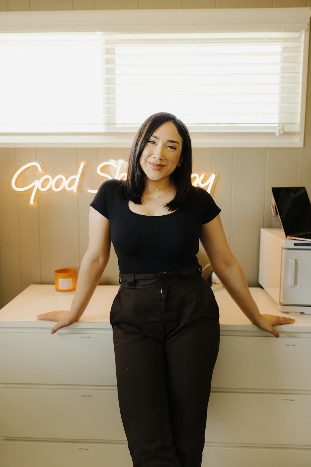 Latina small business owner in a warmly lit everyday workspace